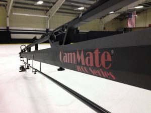 A black CamMate camera crane in a spacious indoor studio.