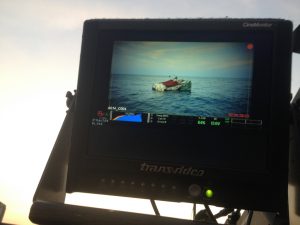A boat on the sea shown on a camera monitor.